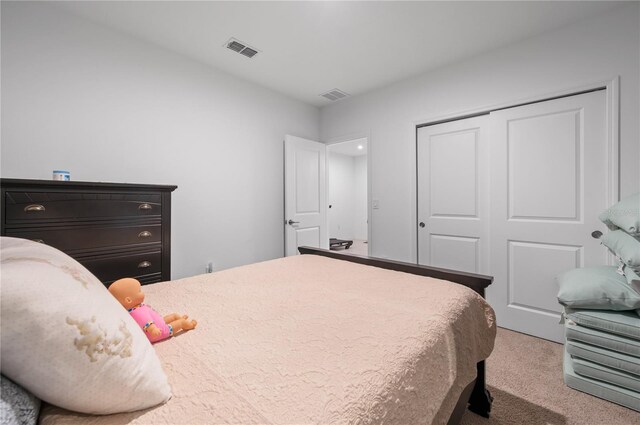 bedroom featuring a closet and light carpet