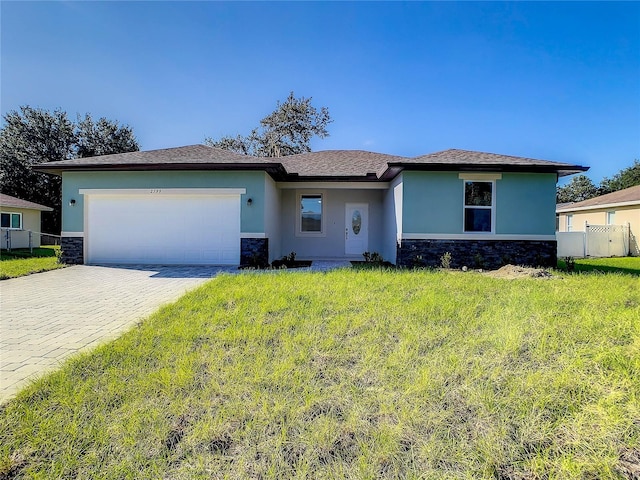 view of front facade with a garage and a front lawn