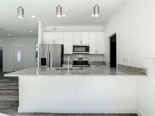 kitchen featuring white cabinetry, appliances with stainless steel finishes, sink, and light stone counters