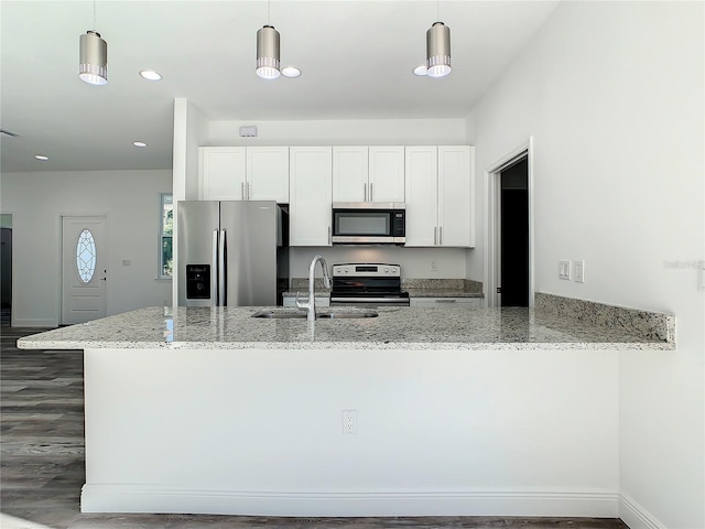 1543 Mackinaw St, North Port, FL 34286 - kitchen with white cabinetry, stainless steel appliances, a sink, and light stone countertops