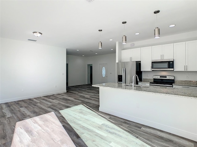 kitchen with white cabinetry, appliances with stainless steel finishes, dark hardwood / wood-style floors, and light stone counters