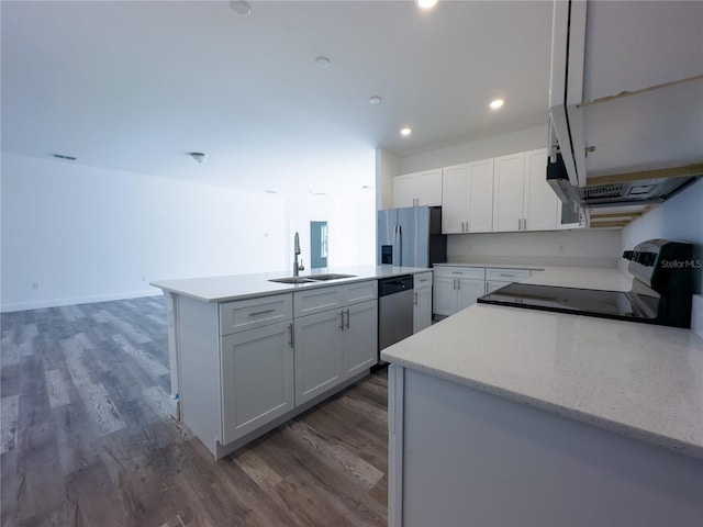 kitchen featuring stainless steel appliances, white cabinetry, dark hardwood / wood-style floors, sink, and a kitchen island with sink