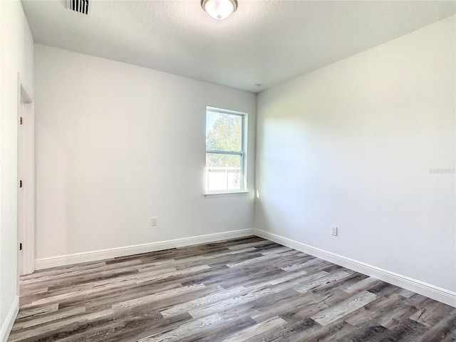 unfurnished room featuring hardwood / wood-style flooring