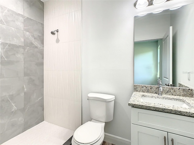 1543 Mackinaw St, North Port, FL 34286 - bathroom featuring vanity, toilet, baseboards, and a tile shower