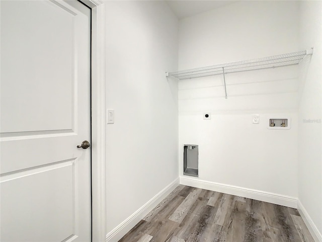1543 Mackinaw St, North Port, FL 34286 - clothes washing area with wood finished floors, laundry area, hookup for an electric dryer, hookup for a washing machine, and baseboards