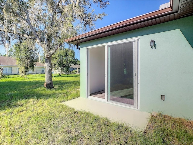 1543 Mackinaw St, North Port, FL 34286 - view of home's exterior featuring stucco siding and a lawn
