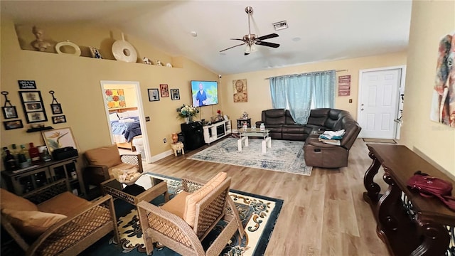 living room with ceiling fan, light hardwood / wood-style floors, and lofted ceiling