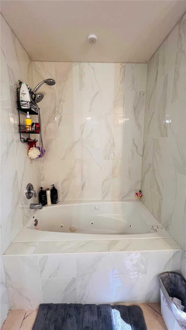 bathroom with tile walls and tiled shower / bath combo