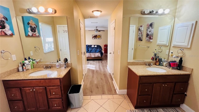 bathroom with ceiling fan, vanity, and hardwood / wood-style flooring