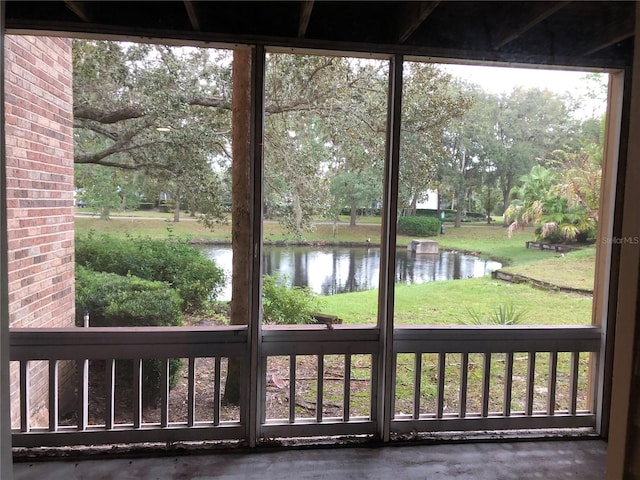 doorway to outside featuring concrete flooring and a water view