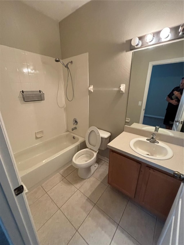 full bathroom with tile patterned floors, vanity, shower / bathtub combination, and toilet