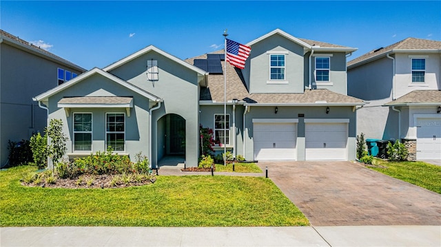 view of front facade with a front yard and a garage