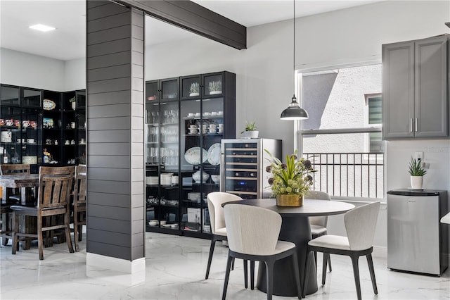 dining space with beam ceiling