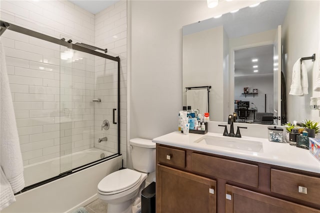 full bathroom with enclosed tub / shower combo, tile patterned floors, vanity, and toilet