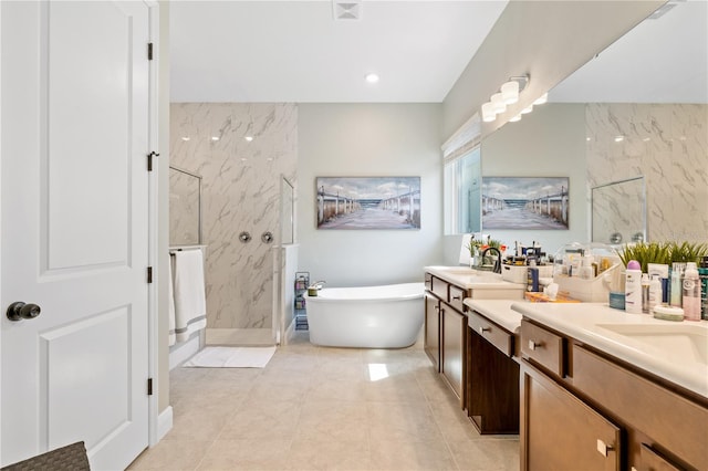 bathroom featuring independent shower and bath, tile patterned flooring, and vanity