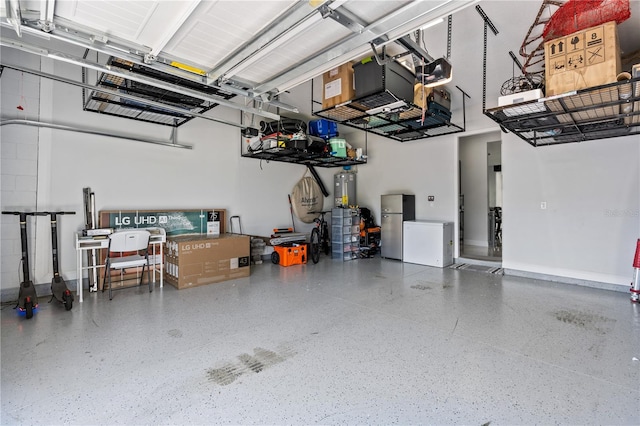 garage featuring water heater and stainless steel refrigerator