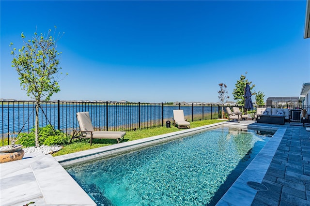 view of pool with a water view and a patio