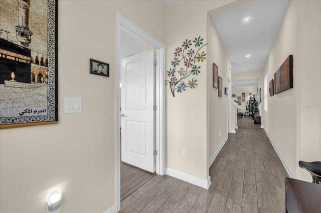 hallway with hardwood / wood-style flooring