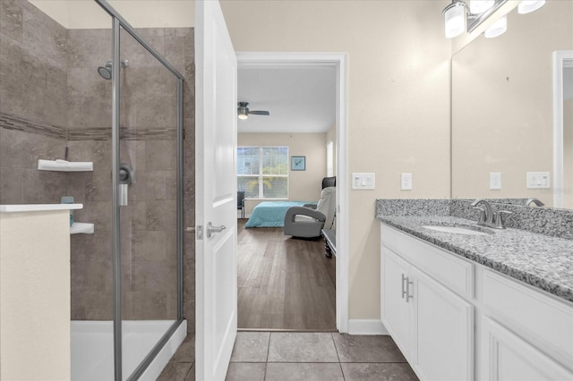 bathroom featuring ceiling fan, a shower with door, vanity, and wood-type flooring