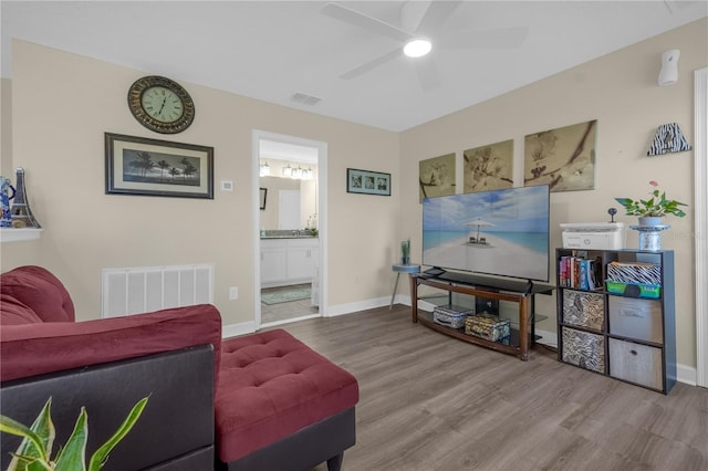 living room featuring wood-type flooring and ceiling fan