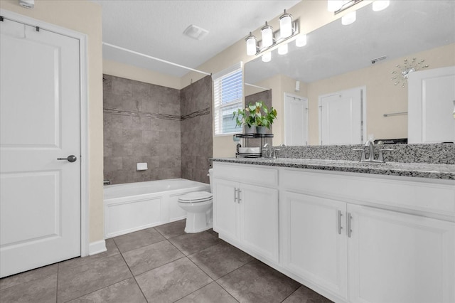 full bathroom featuring tile patterned flooring, a textured ceiling, toilet, vanity, and tiled shower / bath