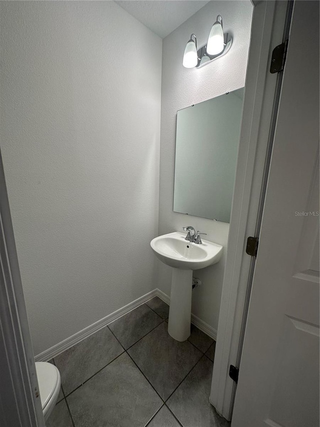 bathroom featuring tile patterned floors and toilet