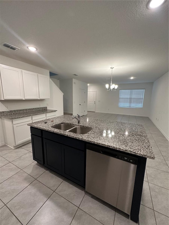 kitchen featuring stainless steel dishwasher, sink, white cabinetry, hanging light fixtures, and an island with sink