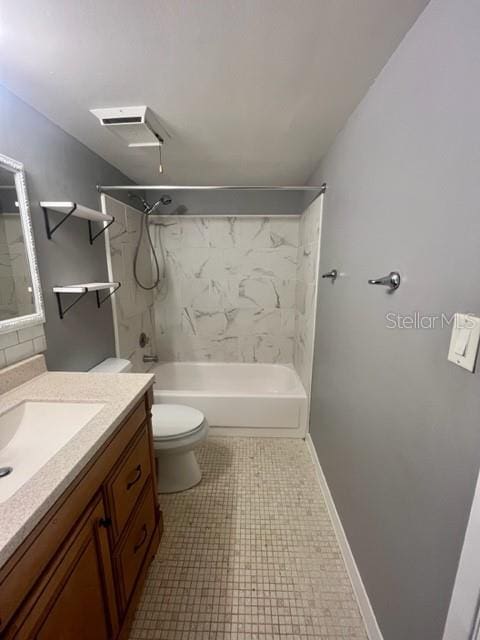 full bathroom with vanity, tiled shower / bath combo, and toilet