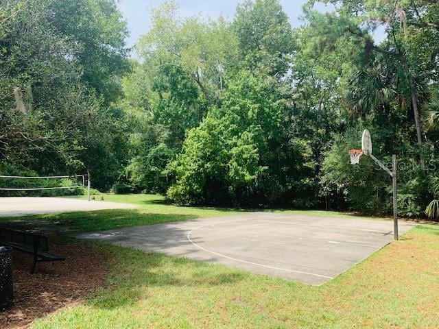 view of basketball court featuring a lawn and volleyball court