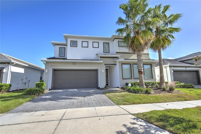 view of front of house featuring a garage and a front yard