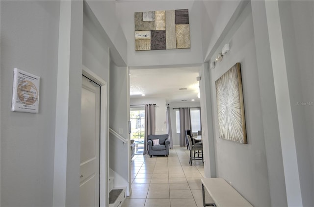 hall featuring light tile patterned flooring