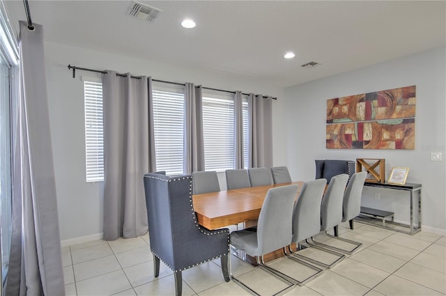 tiled dining space featuring a wealth of natural light