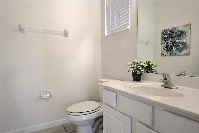 bathroom with tile patterned flooring, vanity, and toilet