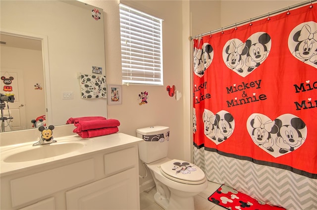 bathroom with toilet, vanity, tile patterned flooring, and walk in shower