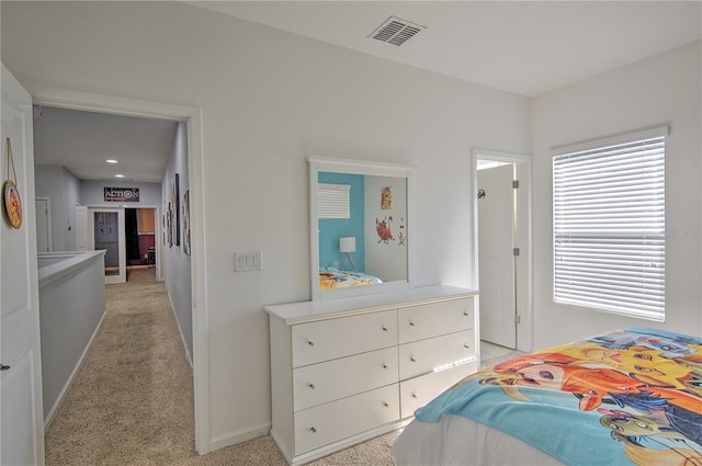 bedroom featuring light carpet