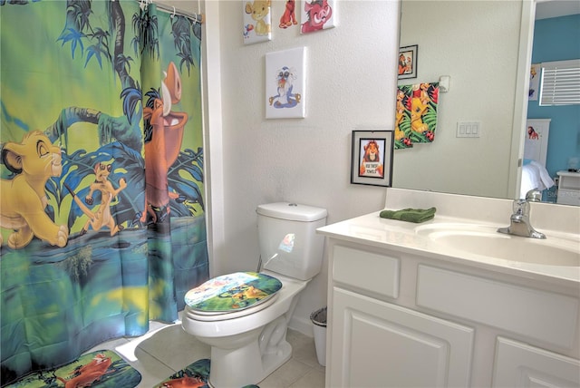 bathroom featuring tile patterned flooring, vanity, and toilet