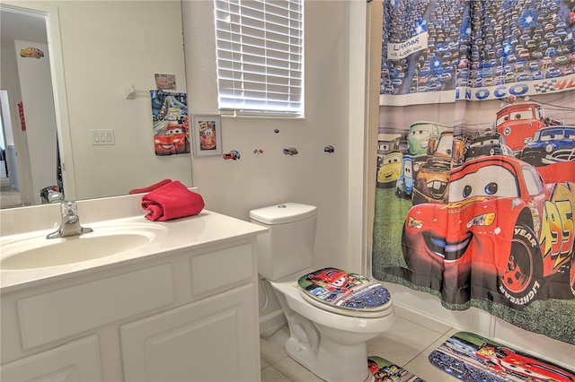 bathroom with toilet, vanity, a shower with shower curtain, and tile patterned floors