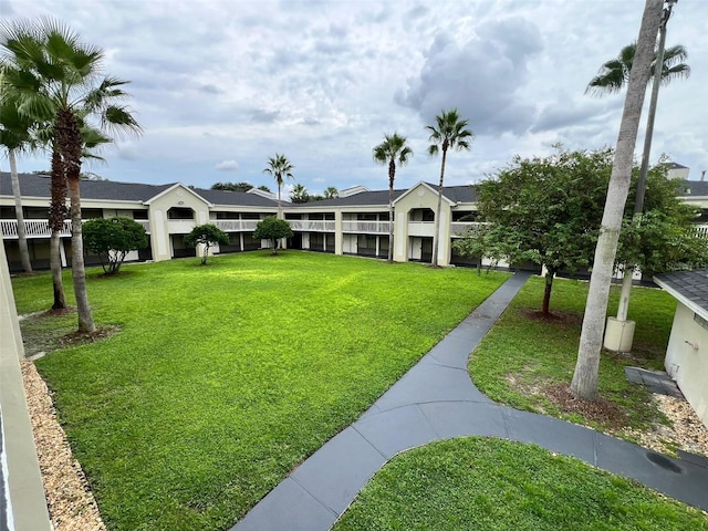 view of home's community with a yard