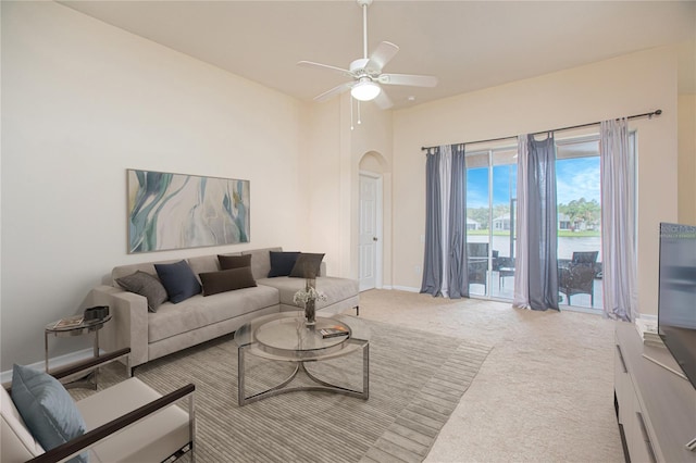 carpeted living room with ceiling fan