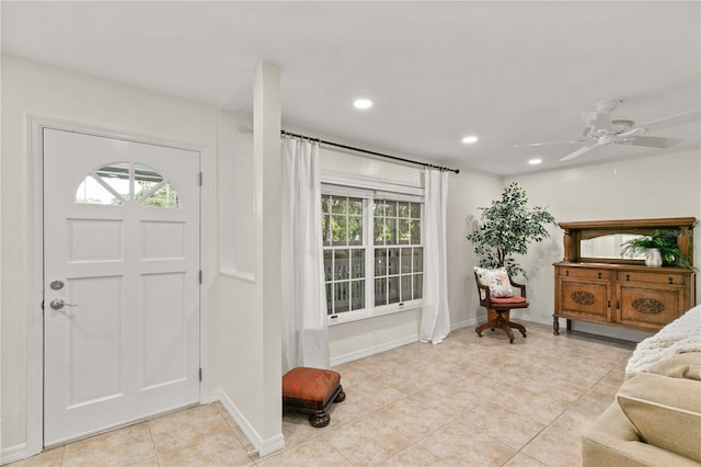 tiled foyer with a wealth of natural light and ceiling fan