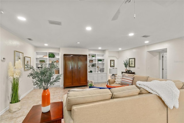 living room featuring ceiling fan, light tile patterned flooring, and built in features