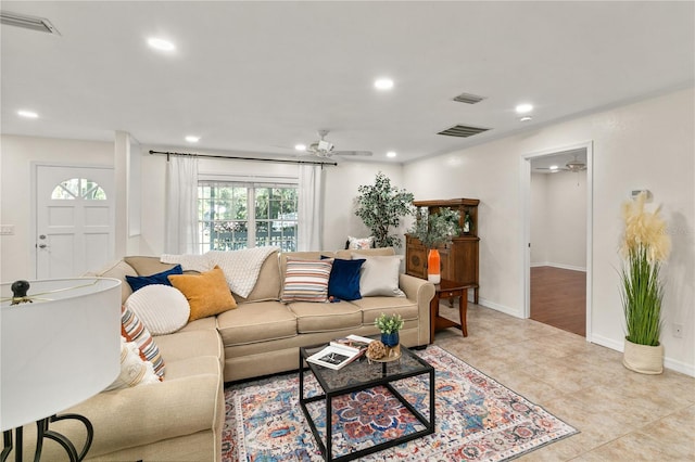 living room with light tile patterned floors and ceiling fan