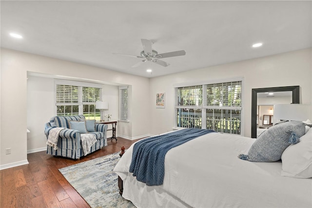 bedroom with dark hardwood / wood-style floors and ceiling fan