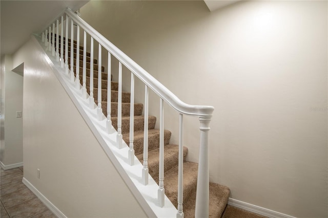 stairway featuring tile patterned flooring