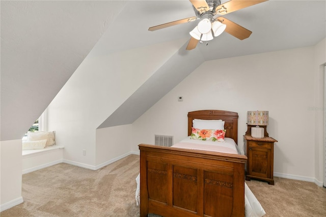 bedroom with ceiling fan, light carpet, and vaulted ceiling