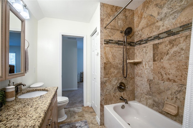 full bathroom featuring vanity, tiled shower / bath combo, toilet, and lofted ceiling