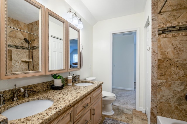 full bathroom featuring vanity, tiled shower / bath combo, and toilet