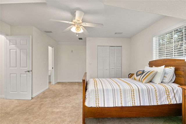 bedroom with ceiling fan, a closet, and light colored carpet