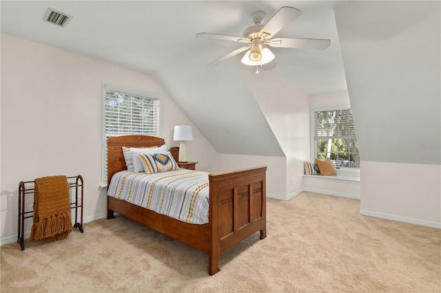 bedroom featuring multiple windows, light colored carpet, and ceiling fan