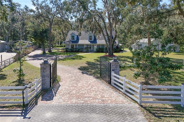 view of gate featuring a lawn